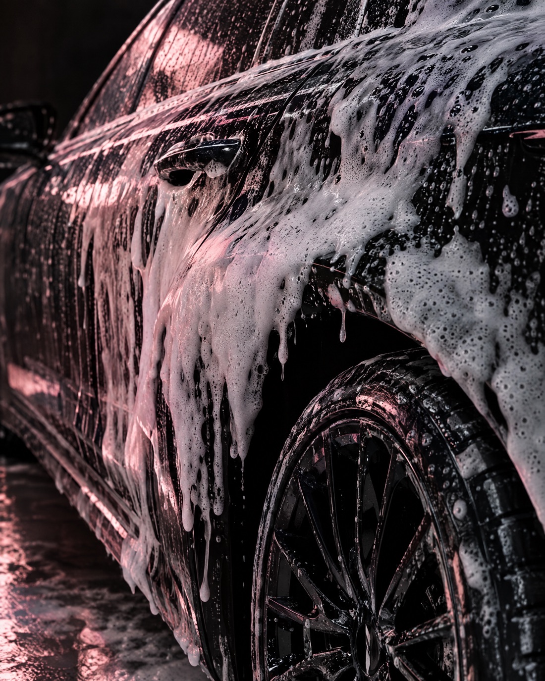 Snow foam on a dark car
